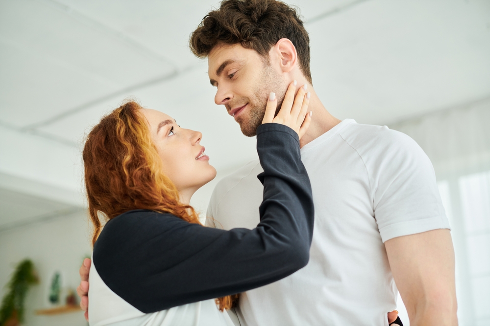 A man and a woman gaze at each other, locked in a silent moment of connection and understanding.