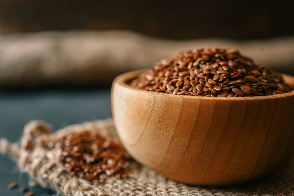 Flax seed in a wooden bowl. Close-up.