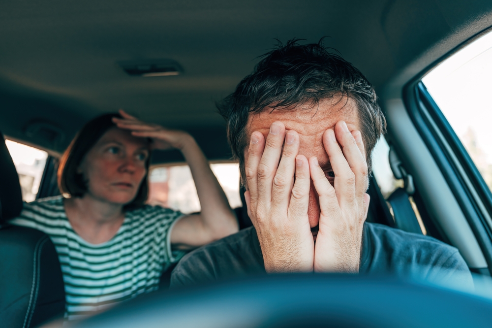 Man and woman quarrel in car, couple arguing during road trip, selective focus