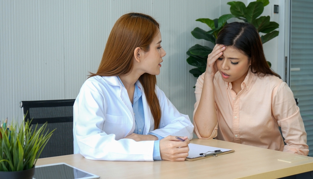 Woman doctor holding hands patient encourage cheer up consultation at hospital medicare treatment clinic. Doctor talking to patient support giving hope listening takecare for mental health therapy