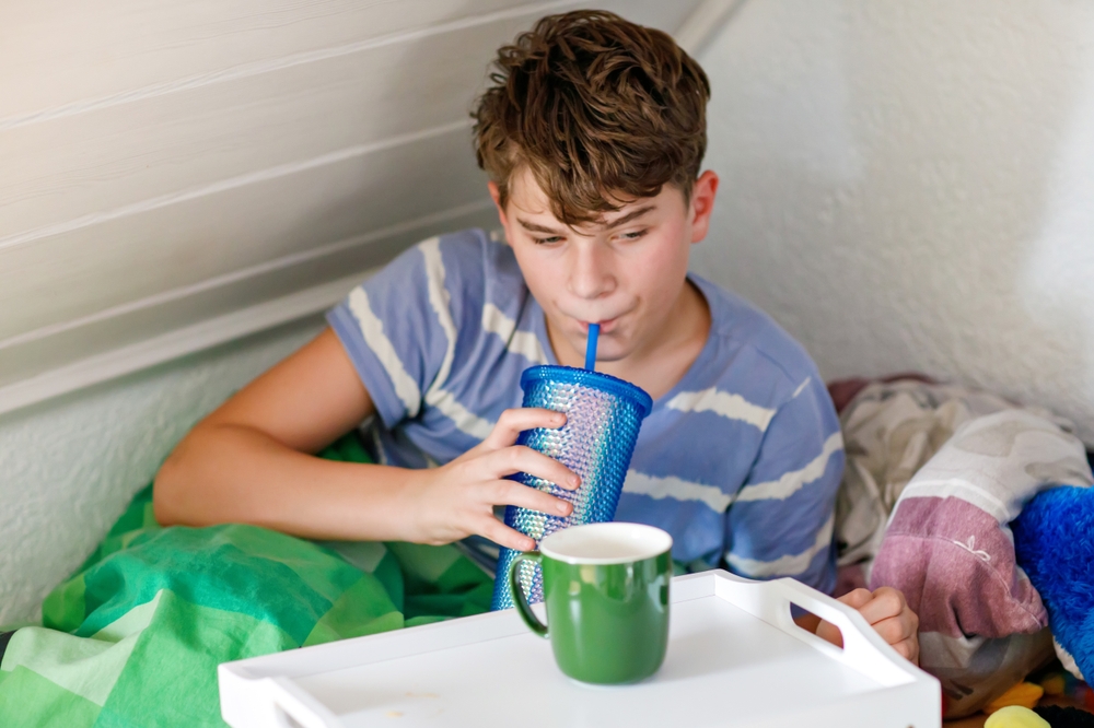 Sick boy sleeping. Sad teen with the flu rests alone at home in a cold winter day. Child with seasonal infections and fever Health disease and drugs concept