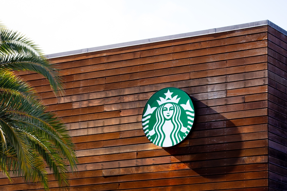 San Jose, California US - February 14, 2025: closeup of Starbucks logo sign on the store facade exterior. Starbucks cafe in Silicon Valley. Starbucks Corporation is world's largest coffeehouse chain