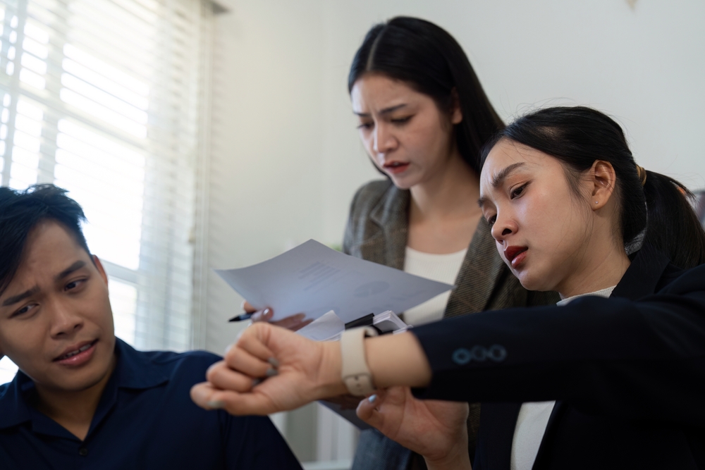Team members reviewing time-sensitive documents in a high-pressure situation.