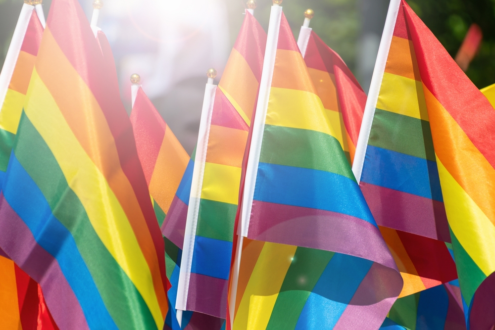 Colorful pride flags waving in sunlight celebrating lgbtq+ diversity and inclusion.