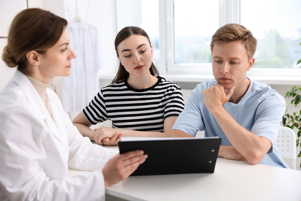 In vitro fertilization (IVF). Couple having appointment with doctor in reproductive clinic