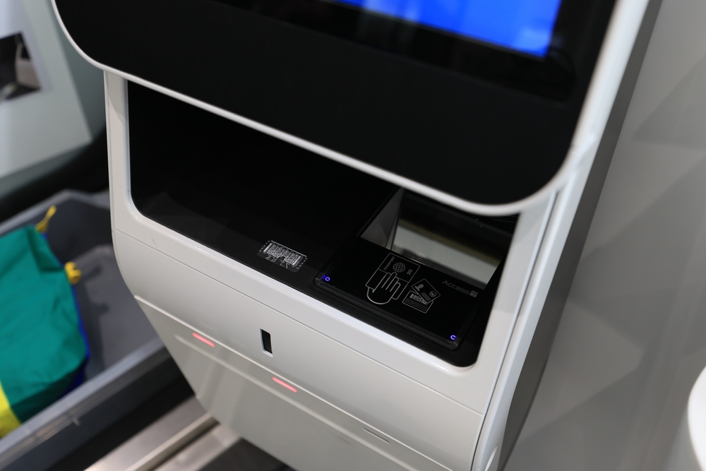 Close-up of a passport and ticket scanner on an airport self-service kiosk.