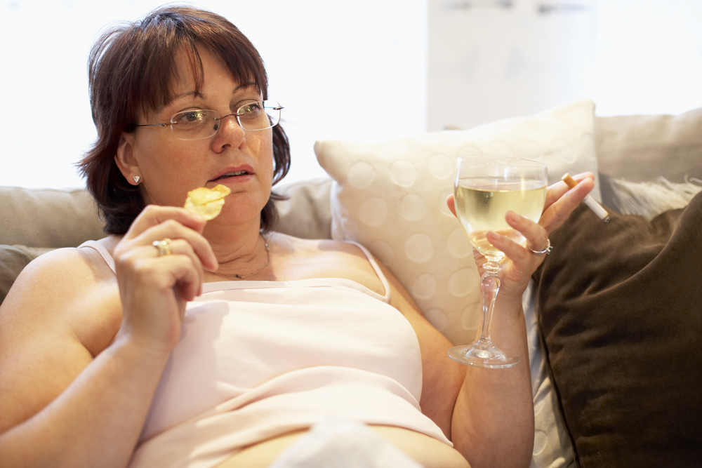 Overweight Woman Relaxing On Sofa