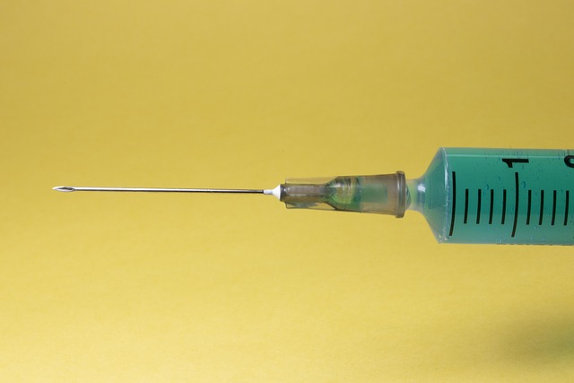 Close up syringe with yellow background