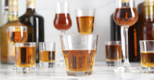 Passenger Who Died on Cruise Served 33 Drinks, Lawsuit Alleges Multiple different types of alcohol drinks in glasses.