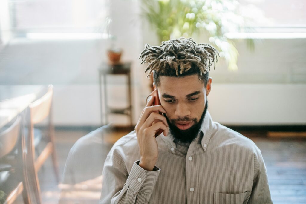 An African American man talking on the phone in an office room