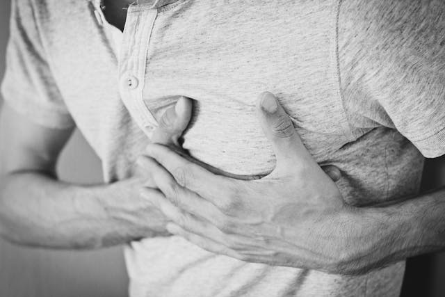 man holding chest in pain