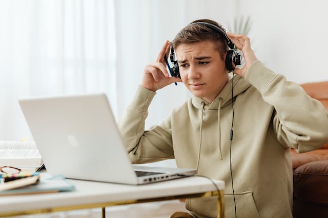 boy listening to music on laptop