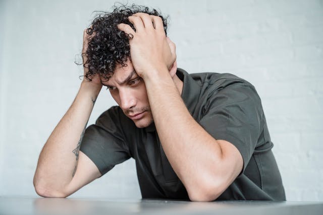 confused man sitting at table