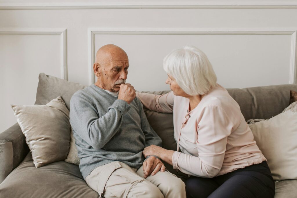 Man in Gray Sweater Sitting Beside Woman
