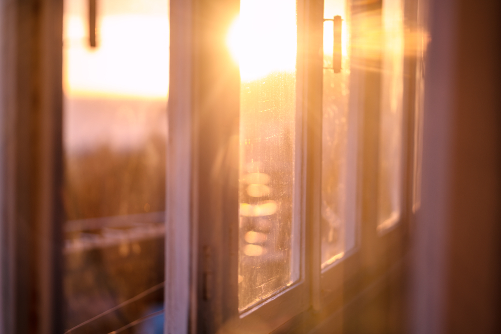View of the evening sunset through a closed window
