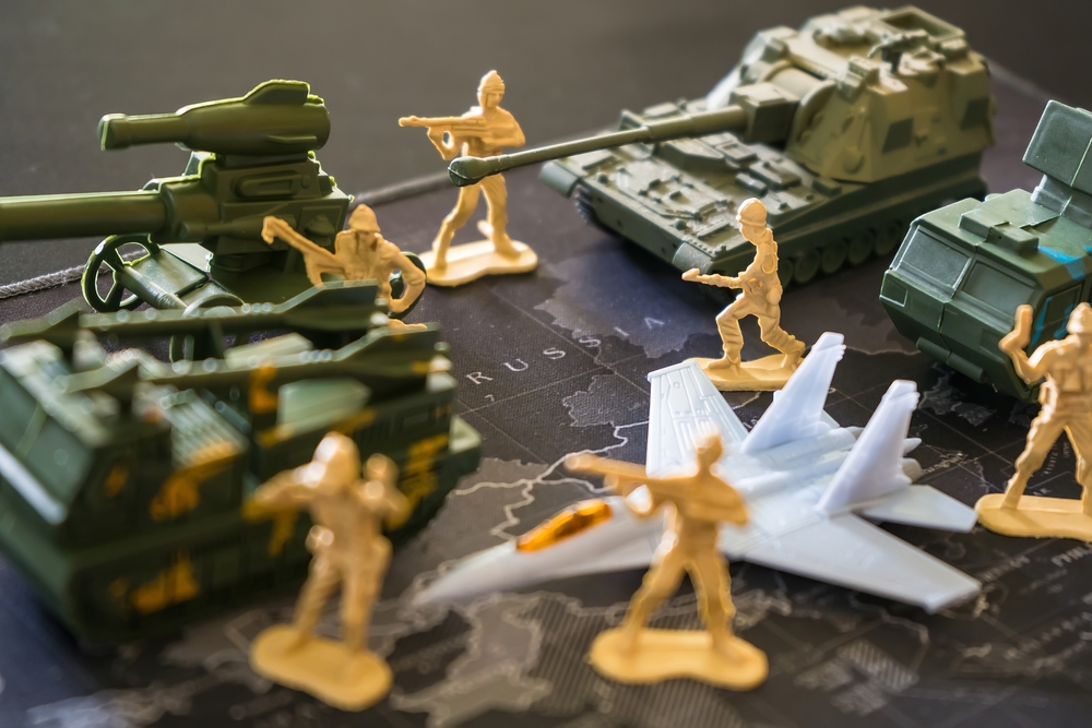 Bangkok, Thailand - March, 16, 2022 : Green toy soldier doll They are waging war on the world map. Russian War of Ukraine War Concept