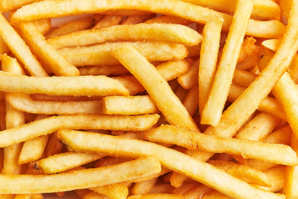 A close-up of golden french fries fills the frame, perfect for food and restaurant themes.