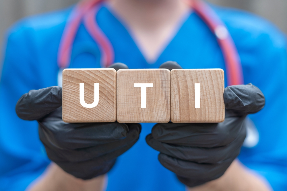 Urologist holding wooden cubes with abbreviation: UTI. UTI Urinary Tract Infection Medical Concept. Modern diagnostics and treatment of urinary tract diseases.