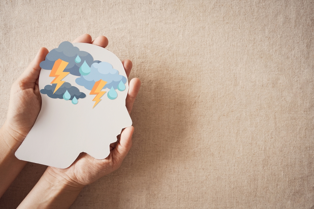 Hands holding brain paper thunder storm, mental health, stress, fear attack concept