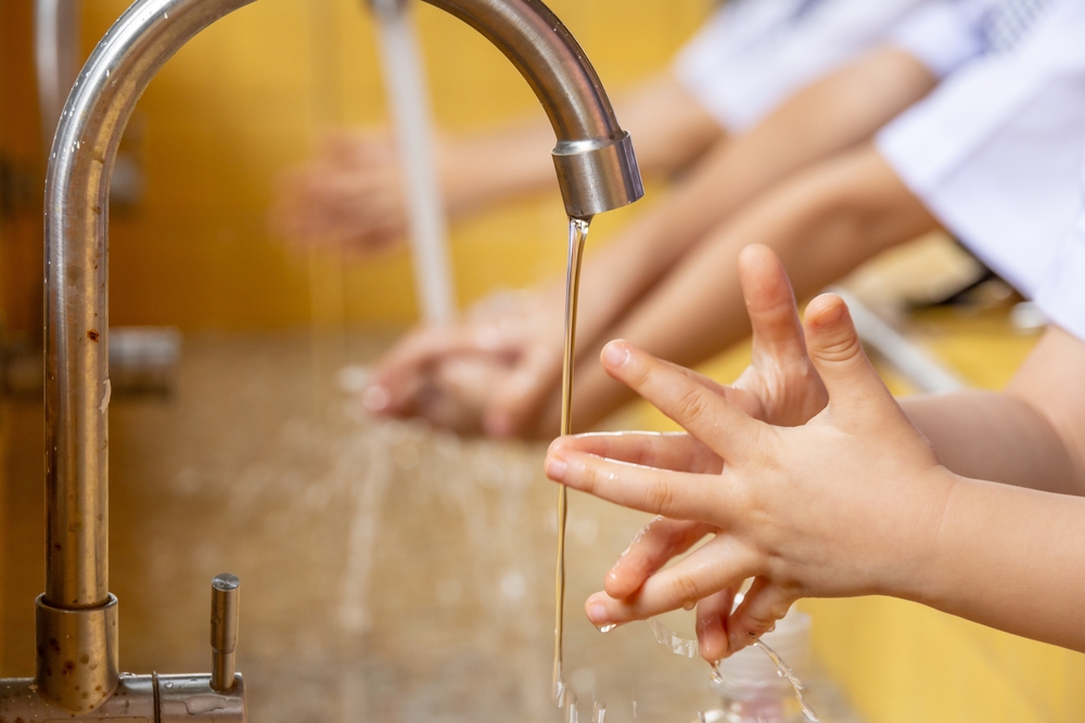 cover children's hands Washing hands with water, copy space for text, concept of clean and Hygiene,Coronavirus and Covid-19 concept, Washing children's hands with water at home. Eliminate the coronavirus outbreak.
