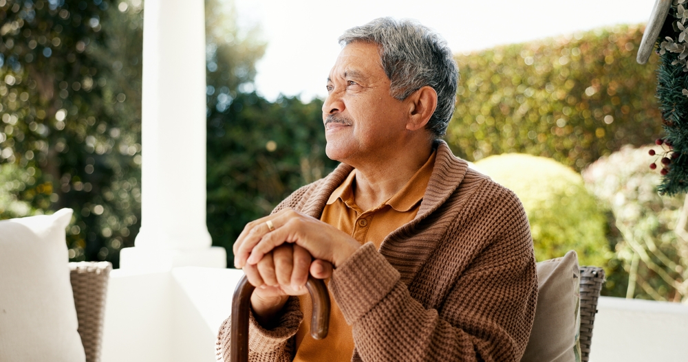 Thinking, senior and man with disability at house for memory, nostalgia and past reflection. Elderly, male person and relax with lonely thoughts, mourning loss and planning for retirement in backyard