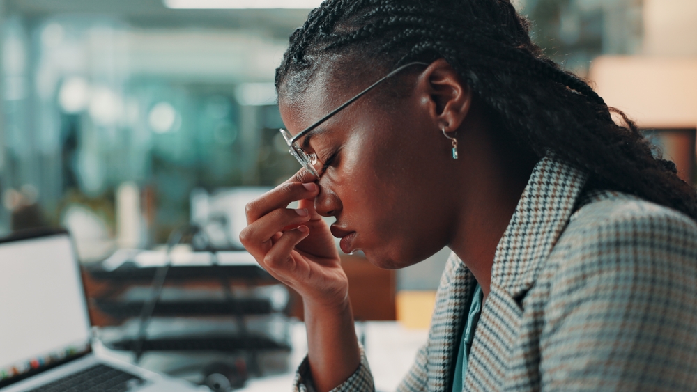 Professional, female and office eye strain headache with article deadline, brain fog and burnout. A black man, a journalist and a migraine with the wrong medicine, fatigue and depression
