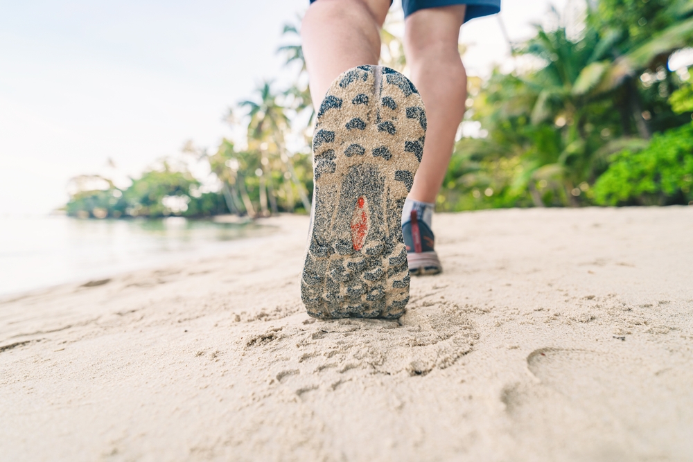 mens walk on sandy beach