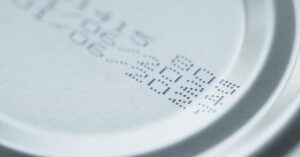 15+ Foods That Almost Never Expire and Why Expiration Dates Mislead Close up of expiry date on the top of a can of food