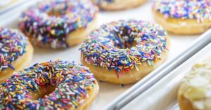 Close up of sprinkled donuts in display case