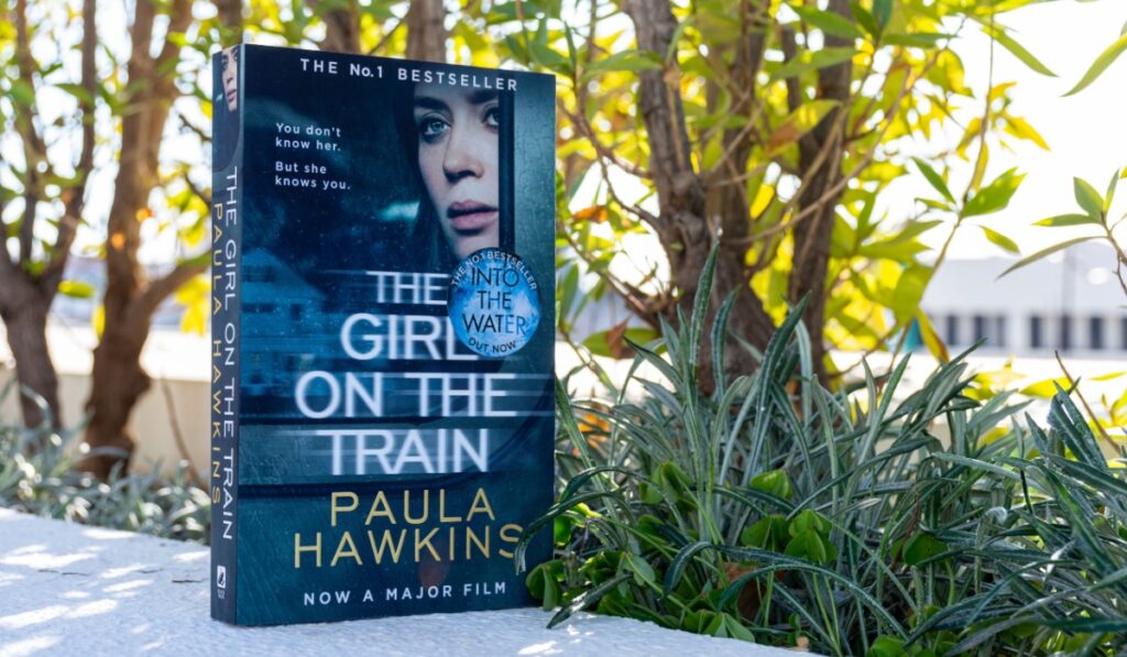 Close-up of Paula Hawkins's The Girl on the Train novel in the garden