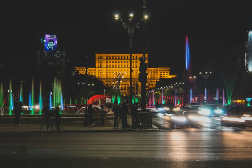 Pedestrians on Sidewalk in City at Night
