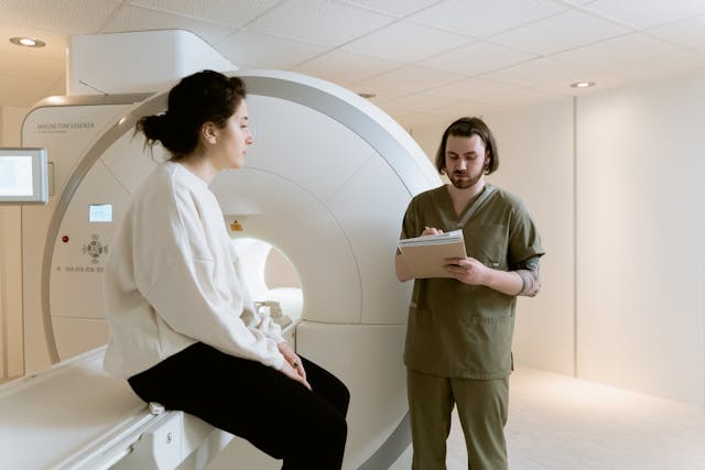 doctor and patient by MRI machine