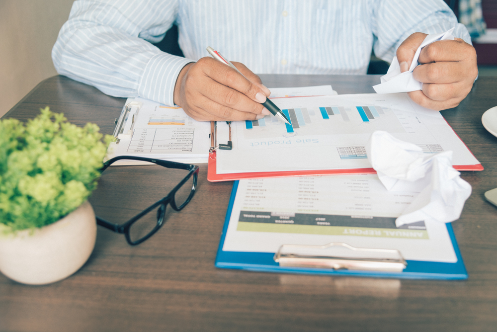 the manager misspelling financial document .He was stressed ,tired and unhappy with wrong paperwork when reading report.