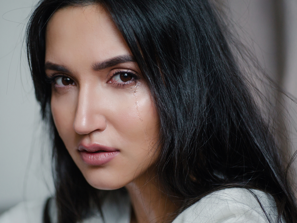 The girl is crying. Sadness is trouble chagrin depression tragedy loss  concept. Misfortune abuse divorce break off relations. Flowing tear. Emotional portrait of a beautiful caucasian women