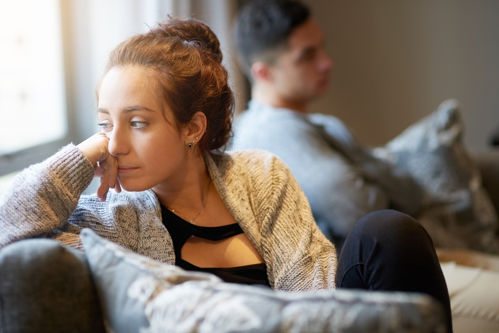 Going through a rough patch. Shot of a young woman looking despondent after a fight with her boyfriend.
