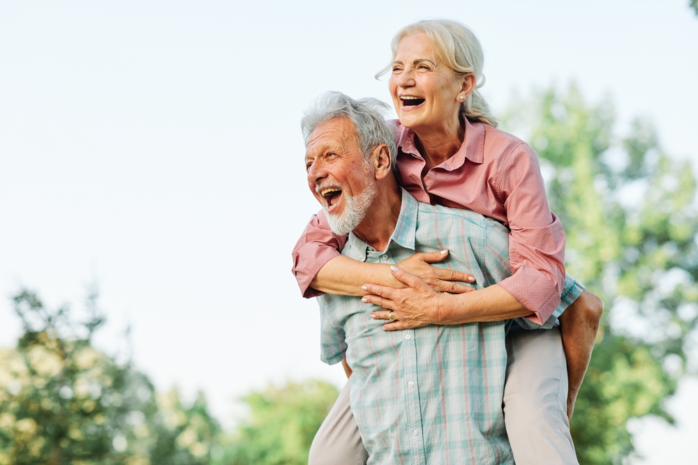 Happy active senior couple having fun outdoors. Portrait of an elderly couple together