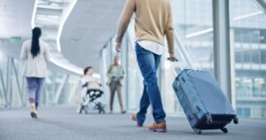 More and More People Are Getting an “Airport Divorce.” Why You Should Consider It Closeup,,Walking,And,Man,With,A,Suitcase,,Back,And,Airport