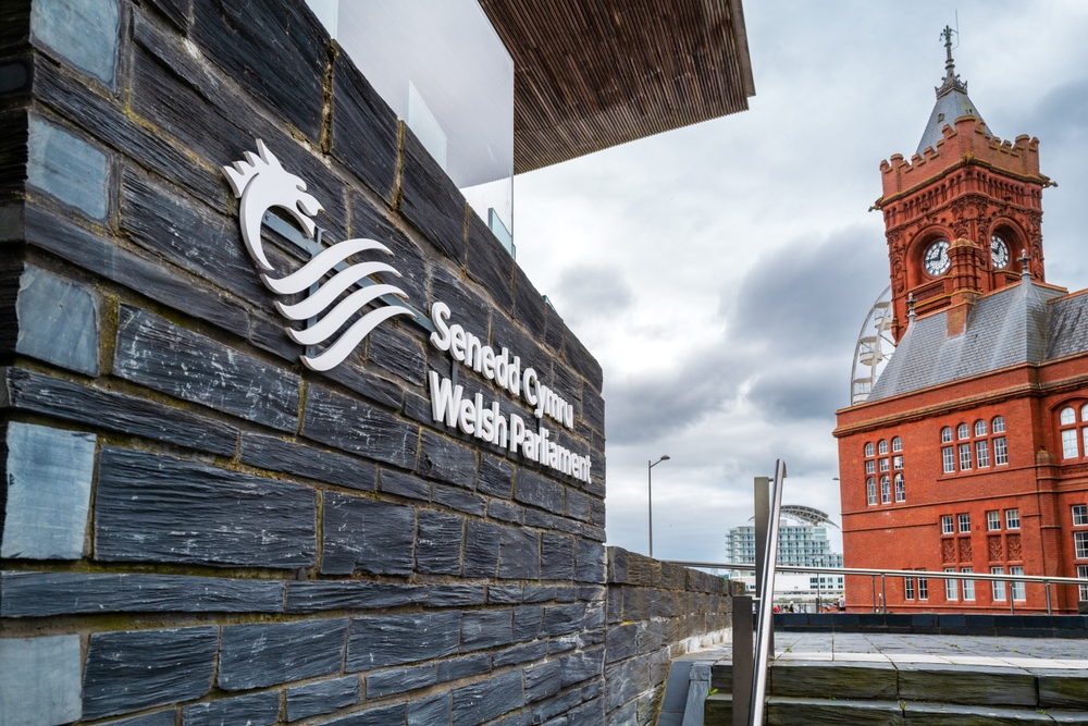 Cardiff, UK - 23 June 2024: Welsh Parliament building, constructed from local slate, Cardiff, Wales. Known as the Senedd. The red brick Pierhead building can be seen in the background.