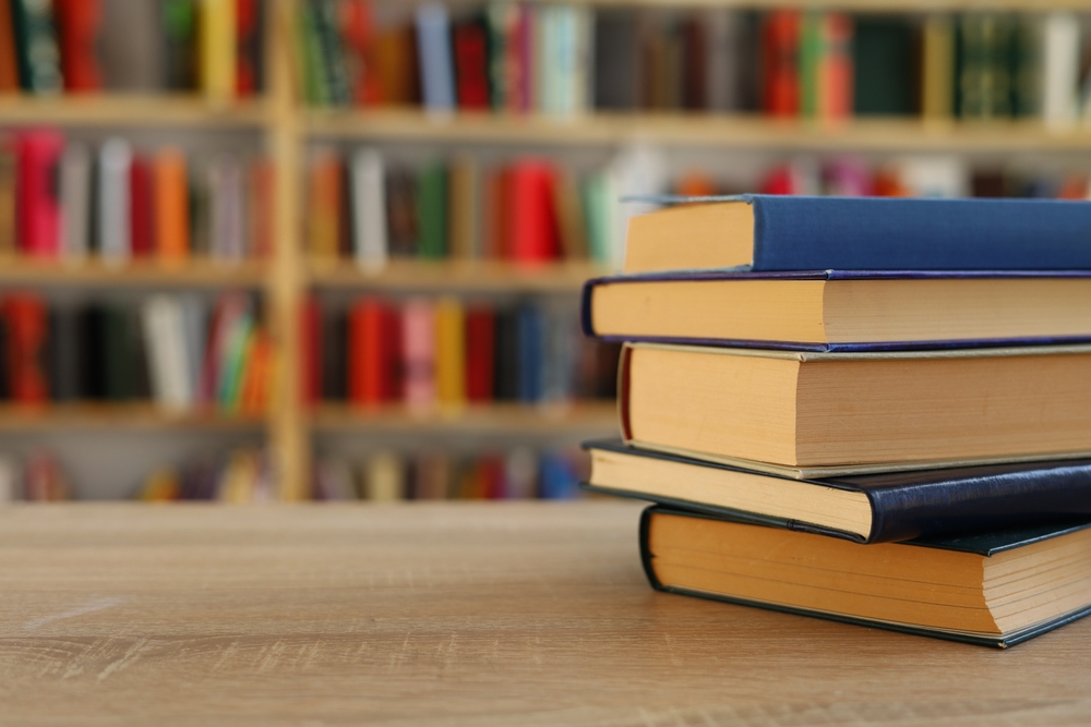 Stack of books on the table in library, education, books