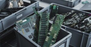 electronic waste (e-waste), specifically printed circuit boards from computers or other technological devices being sorted for recycling