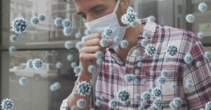 Mysterious Virus With No Known Treatment Spreads Quickly Along the West Coast man coughing wearing mask surrounded by airborne virus particles