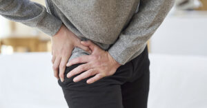 5 Common Reasons for Hip Pain and What They Might Mean man holding hip in pain