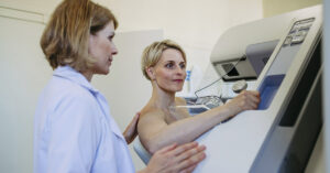 woman undergoing mammogram, breast cancer screening