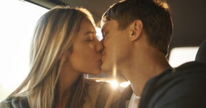 man and woman kissing