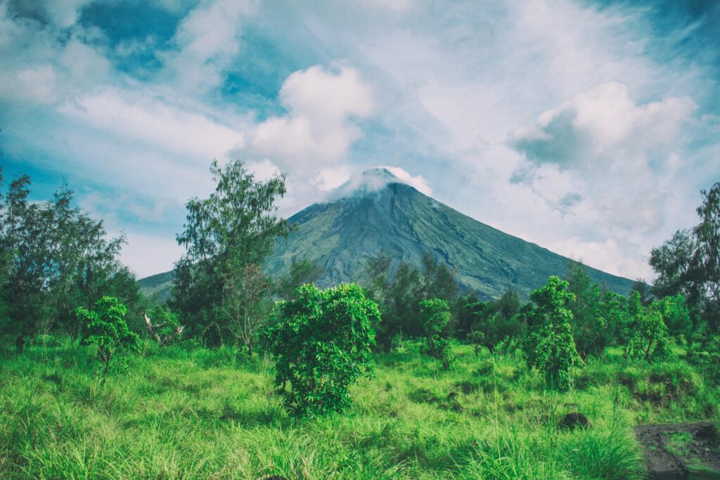 Landscape Photography Of Mountain Under Cloudy Sky