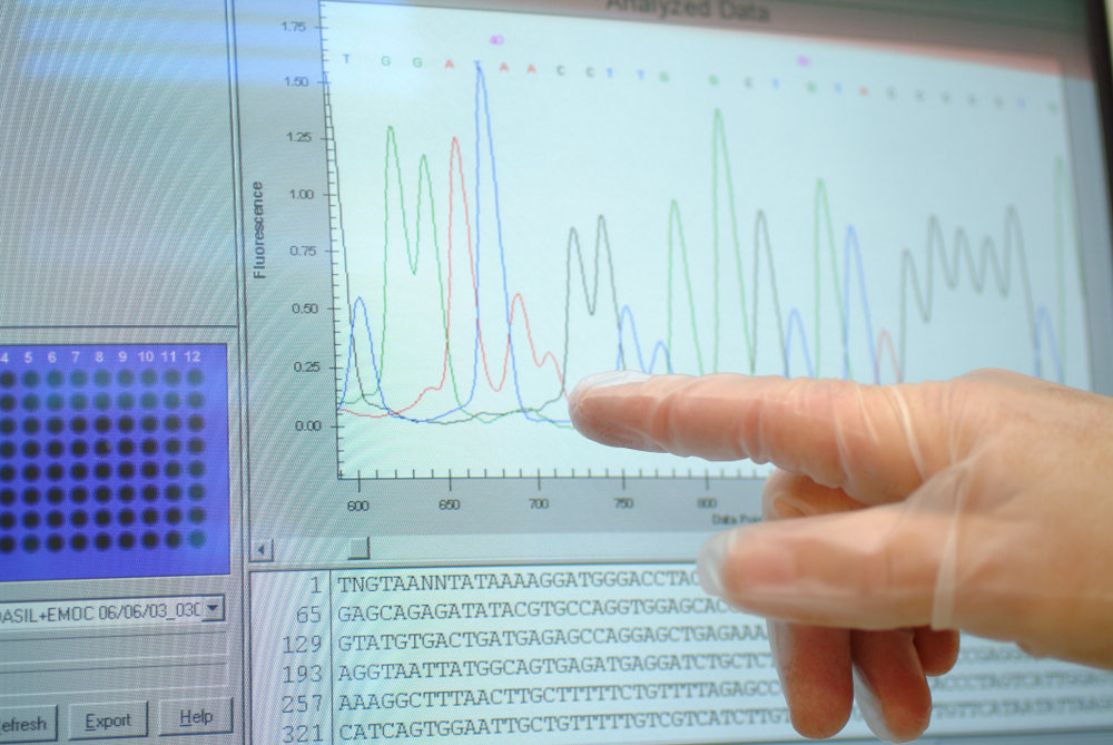 Sequencing human DNA on a hospital research center computer screen highlighting the RNA nitrogen bases: adenine, guanine, cytosine and thymine