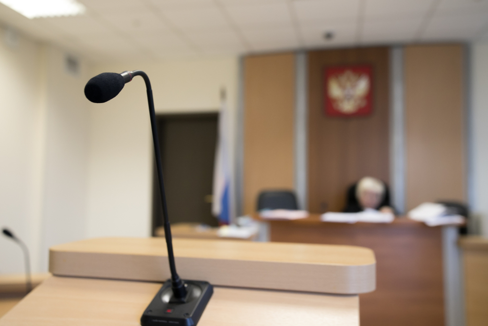 Wooden table in court of law with microphone and gavel