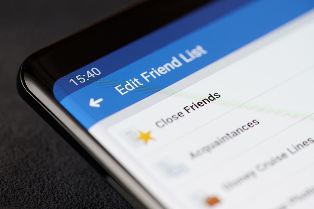 New york, USA - march 11, 2019: Close friends in facebook account on smartphone screen close up view