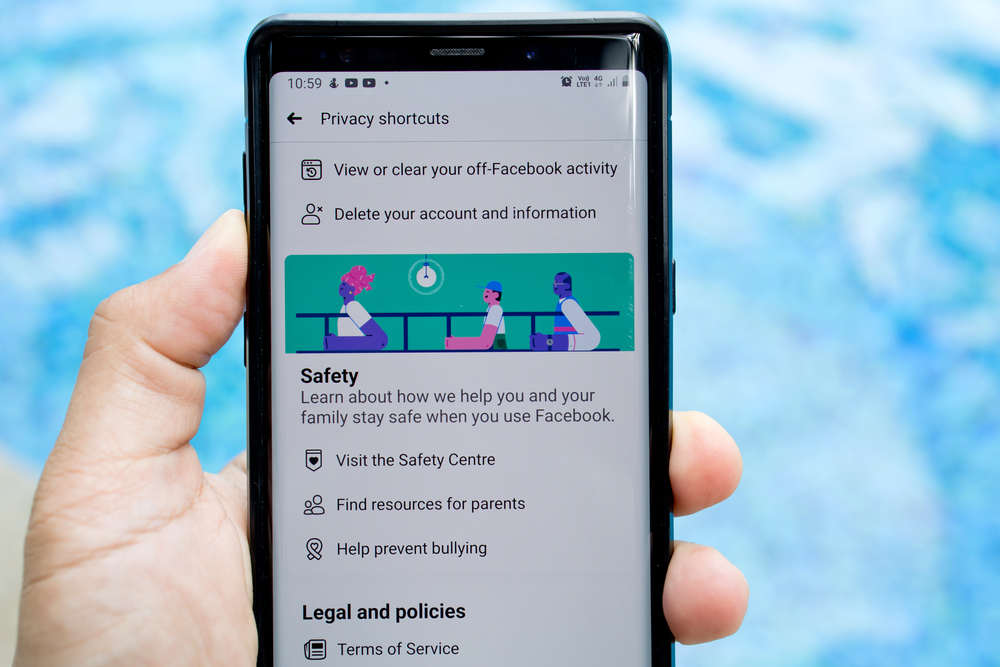 PENANG, MALAYSIA - 1 SEP 2020: Close up man browsing smartphone with Facebook privacy check-up page. It is an American online social media networking company. Facebook security and privacy issues.