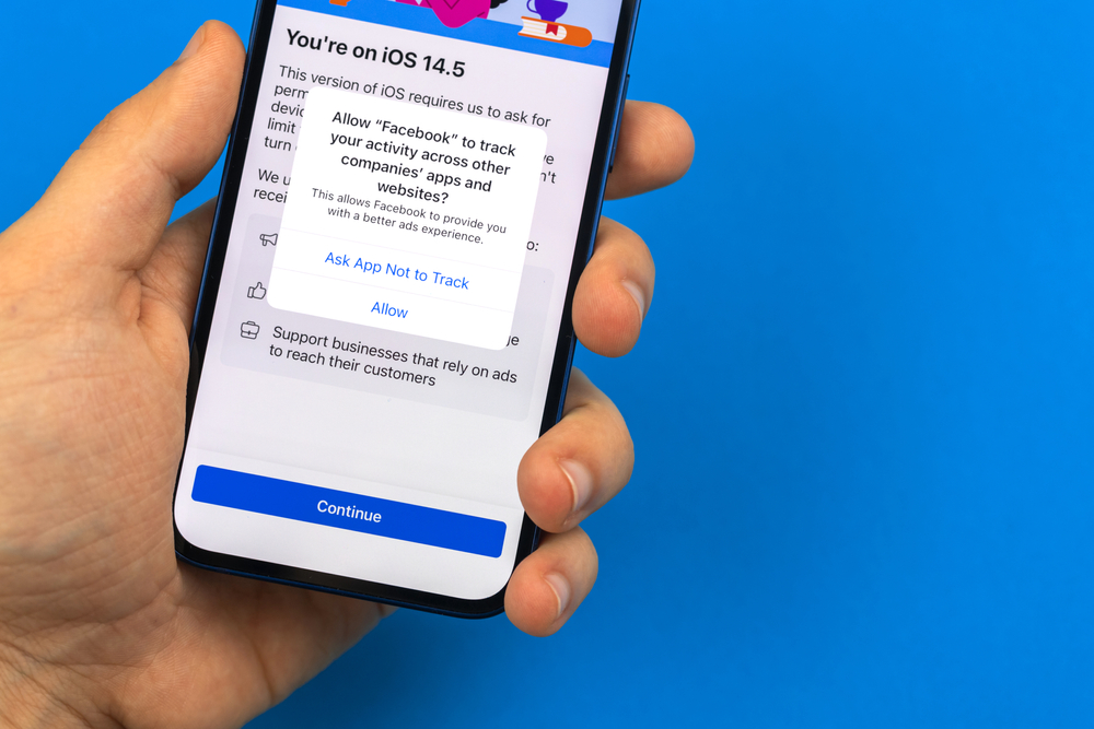 Kharkov, Ukraine - May 28, 2021: Man use Facebook with request permission to track activity across other apps and websites, copy space photo, notification of confidentiality